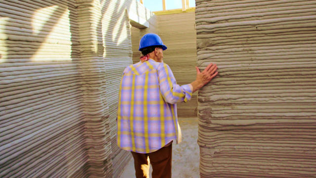 Man explores his new 3D-printed home that is under construction